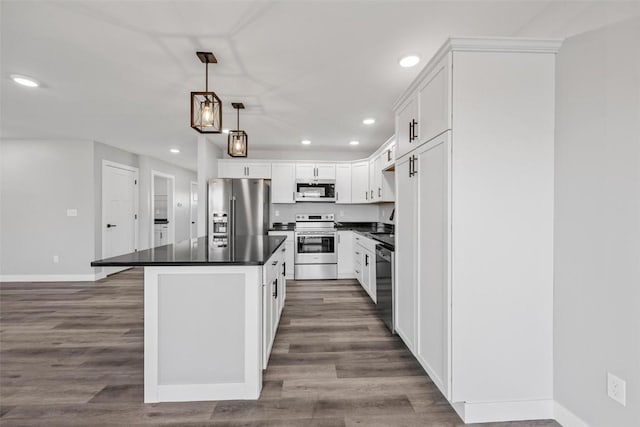 kitchen with white cabinets, dark hardwood / wood-style flooring, hanging light fixtures, and appliances with stainless steel finishes