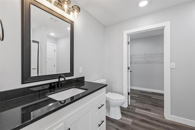 bathroom featuring hardwood / wood-style floors, vanity, and toilet