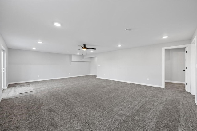 carpeted spare room with ceiling fan