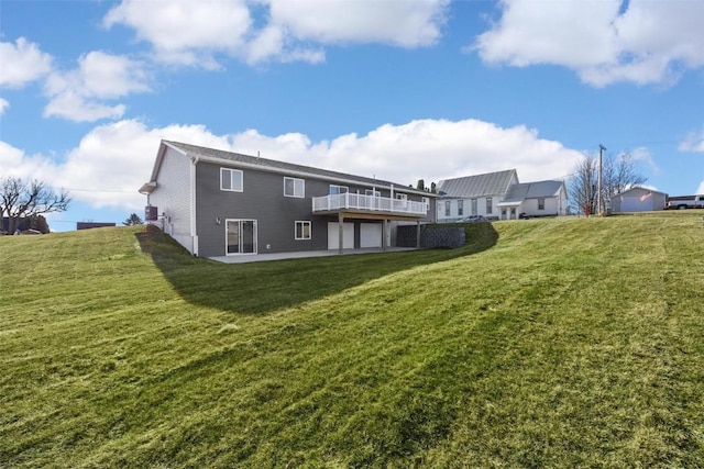 back of house featuring a yard and a wooden deck