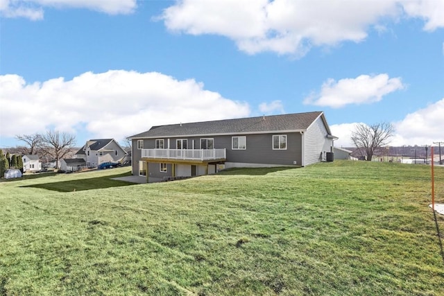 back of house with a wooden deck and a lawn