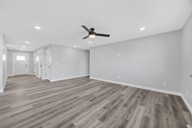 unfurnished living room featuring light hardwood / wood-style flooring and ceiling fan