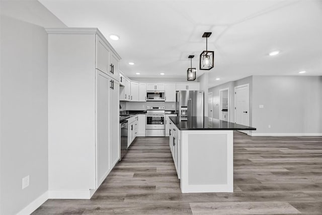 kitchen featuring white cabinetry, light hardwood / wood-style floors, pendant lighting, a kitchen island, and appliances with stainless steel finishes