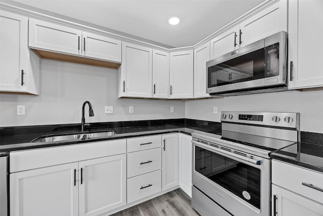 kitchen featuring sink, white cabinetry, and stainless steel appliances