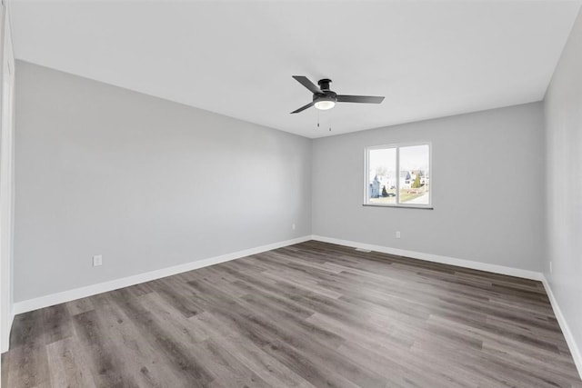 empty room featuring wood-type flooring and ceiling fan