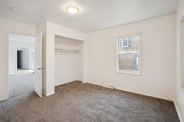 unfurnished bedroom featuring carpet floors and a closet