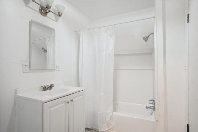 bathroom featuring a notable chandelier, vanity, and shower / tub combo