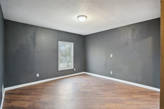 empty room featuring hardwood / wood-style floors and a textured ceiling