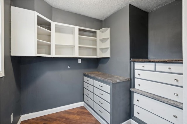 walk in closet featuring dark wood-type flooring