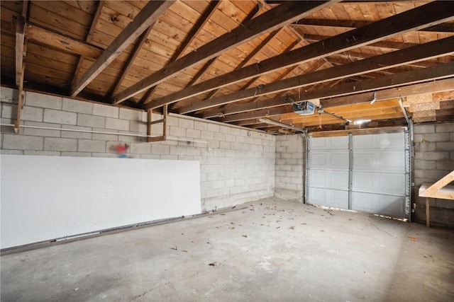 garage with wood ceiling and a garage door opener