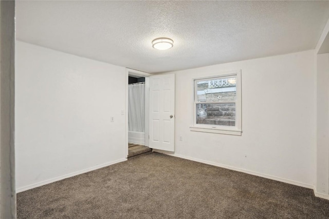 carpeted spare room with a textured ceiling