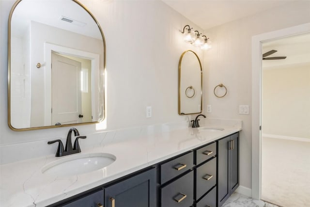 bathroom with ceiling fan and vanity