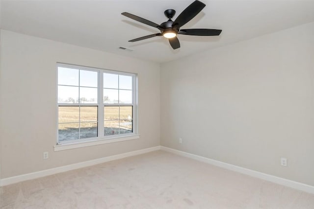 empty room with light colored carpet and ceiling fan