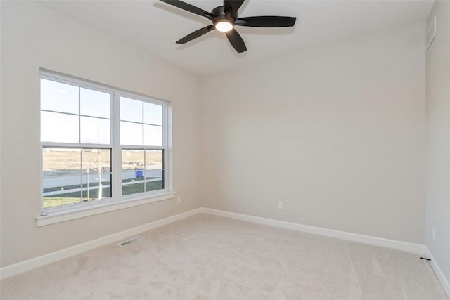 carpeted empty room featuring ceiling fan