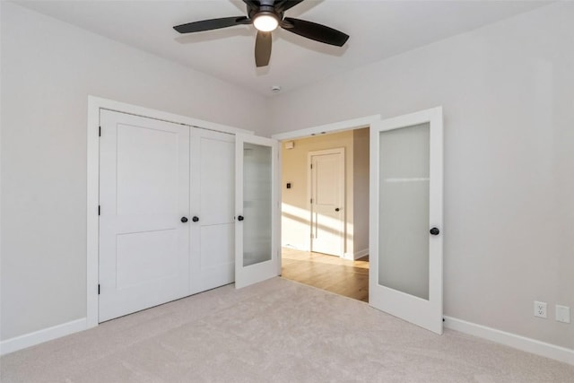 unfurnished bedroom with light carpet, french doors, and ceiling fan