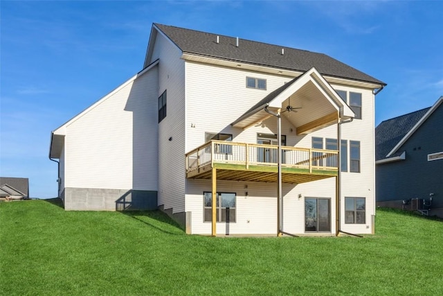 back of property featuring a deck, ceiling fan, and a lawn