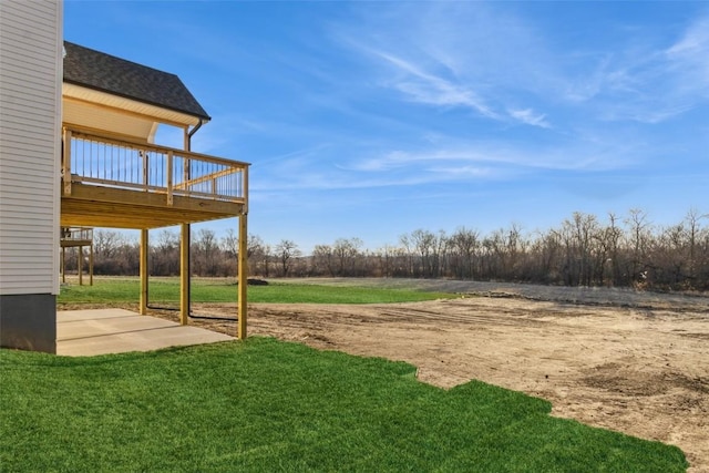 view of yard with a deck and a patio