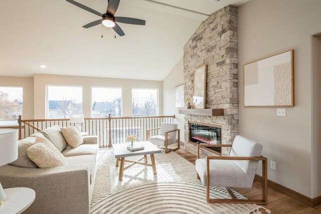 interior space with ceiling fan, a fireplace, wood-type flooring, and lofted ceiling