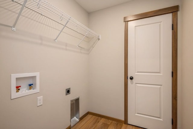 washroom featuring hookup for an electric dryer, light hardwood / wood-style flooring, and washer hookup