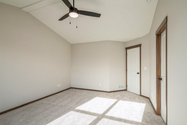 unfurnished bedroom featuring ceiling fan, light carpet, and vaulted ceiling