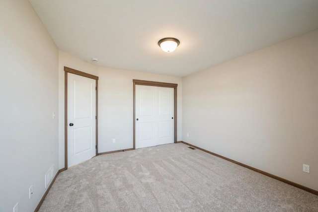 unfurnished bedroom with carpet and a closet