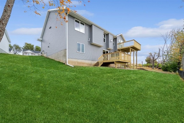 back of property with a lawn and a wooden deck