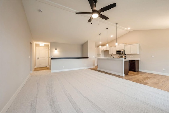 unfurnished living room featuring ceiling fan, vaulted ceiling, and light wood-type flooring