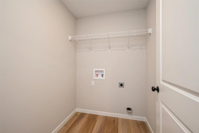 laundry room with washer hookup, light wood finished floors, hookup for an electric dryer, laundry area, and baseboards