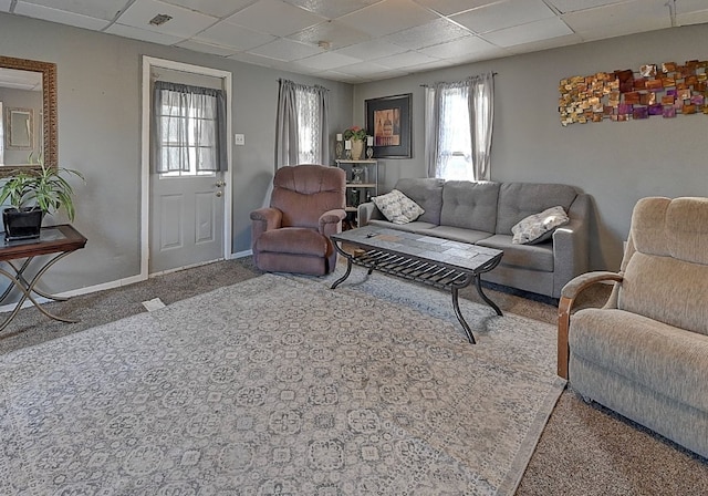 carpeted living room featuring a paneled ceiling