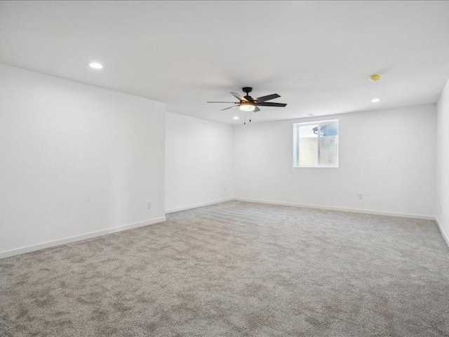 carpeted spare room with ceiling fan