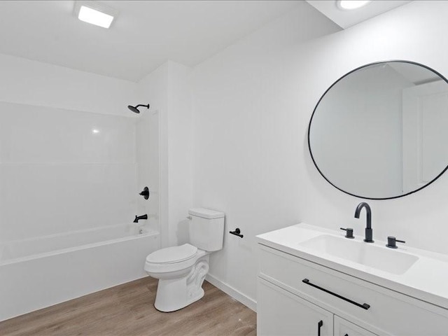 full bathroom with hardwood / wood-style flooring, vanity, toilet, and washtub / shower combination