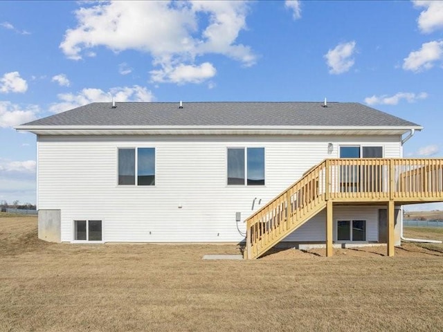 rear view of property with a lawn and a deck