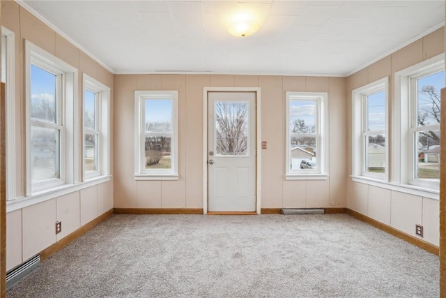 unfurnished sunroom featuring a baseboard heating unit