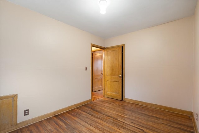 unfurnished room featuring wood finished floors and baseboards