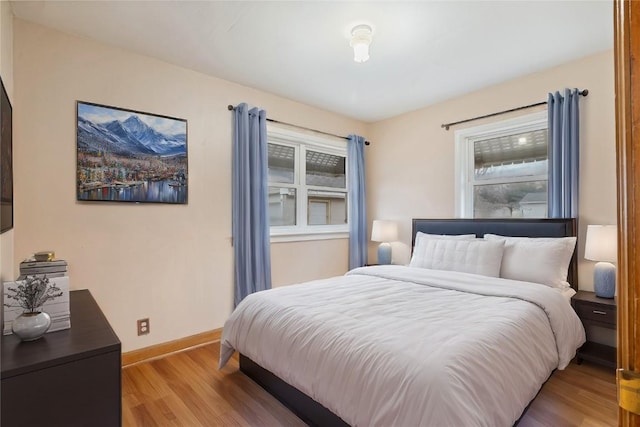 bedroom featuring light wood-style flooring and baseboards