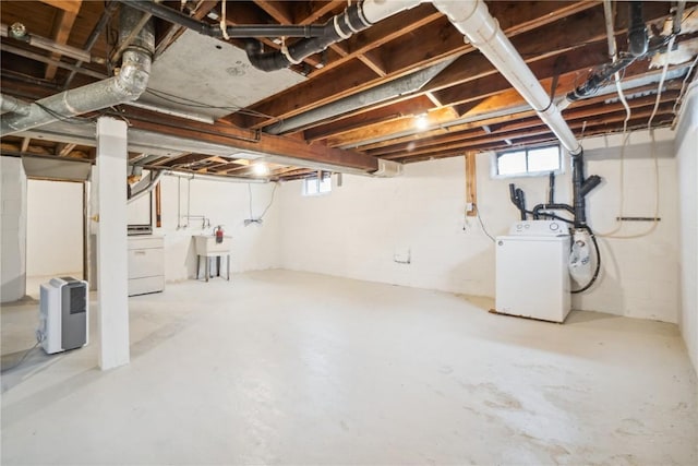 basement featuring washer / clothes dryer and a sink