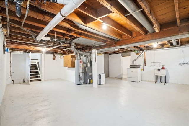 unfinished below grade area with water heater, washer / clothes dryer, stairway, and a sink