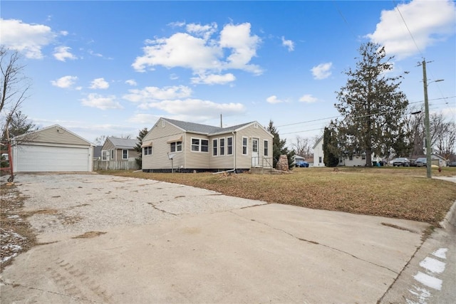 bungalow-style house with a detached garage and an outdoor structure