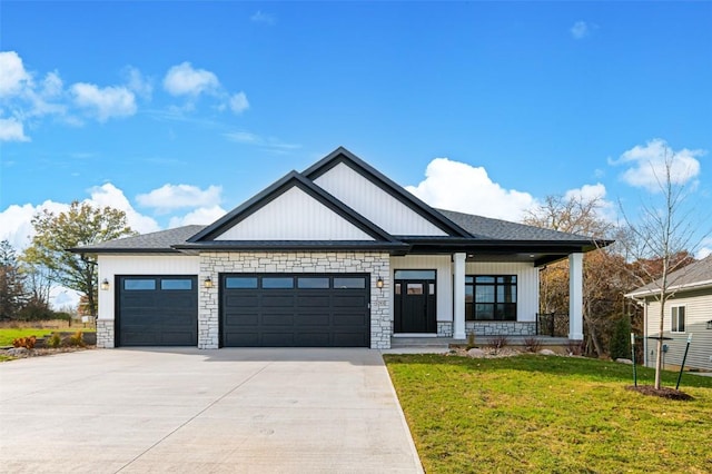 view of front of house with a front lawn, a porch, and a garage