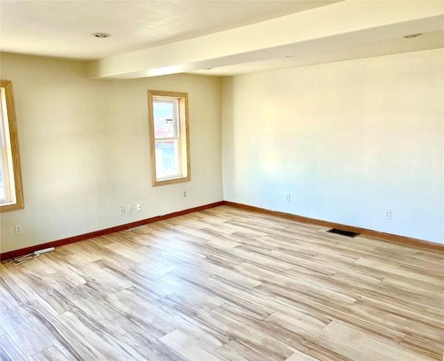 spare room featuring light hardwood / wood-style floors