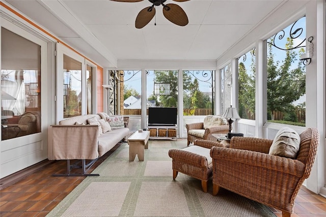 sunroom / solarium featuring ceiling fan and a healthy amount of sunlight