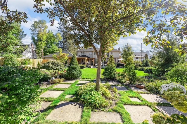 view of home's community featuring a lawn