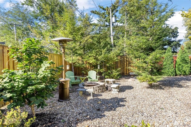 view of yard with an outdoor fire pit