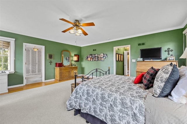 bedroom with wood-type flooring, ceiling fan, and crown molding