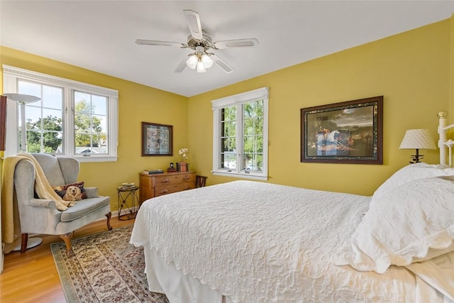 bedroom featuring ceiling fan and light hardwood / wood-style flooring