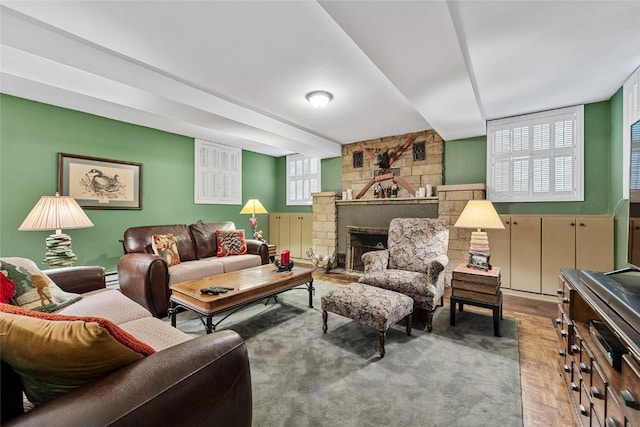 living room featuring baseboard heating, a fireplace, and light hardwood / wood-style flooring