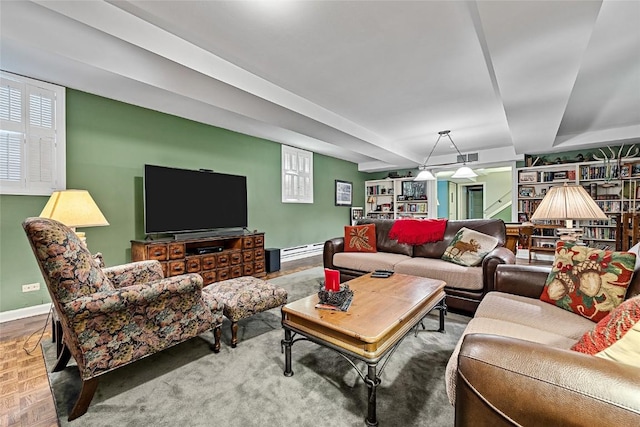 living room with parquet flooring, baseboard heating, and a wealth of natural light