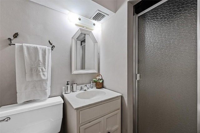 bathroom featuring vanity, an enclosed shower, and toilet