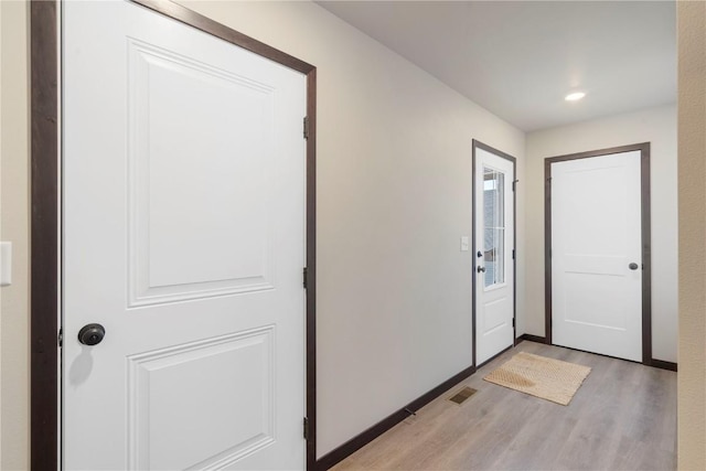 doorway featuring recessed lighting, visible vents, and light wood-type flooring