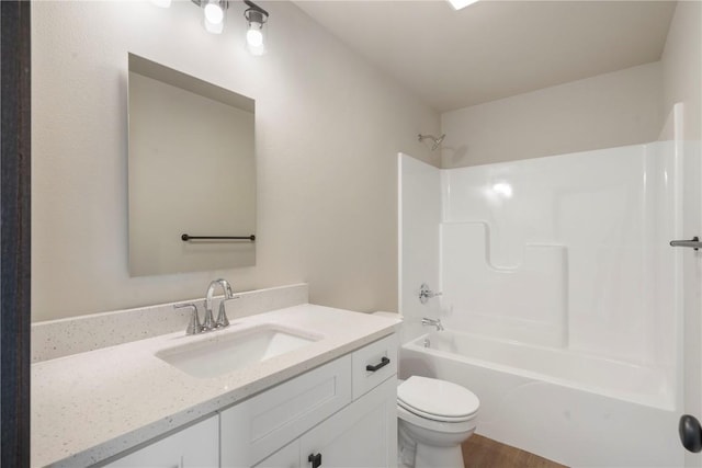 full bath featuring vanity, tub / shower combination, and toilet